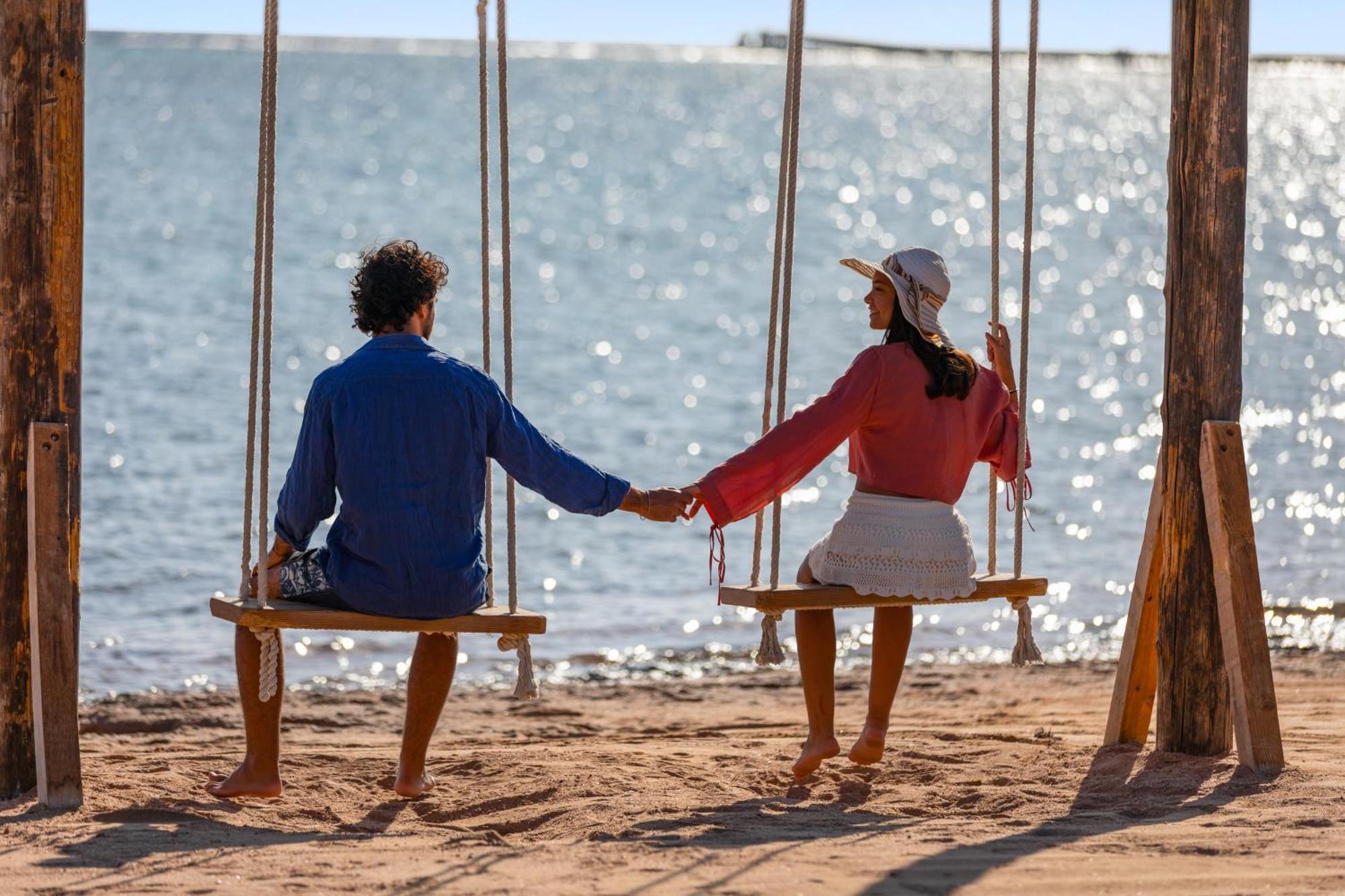 Pickalbatros Royal Moderna Sharm "Aqua Park" Hotel Exterior photo A couple holding hands on a swing